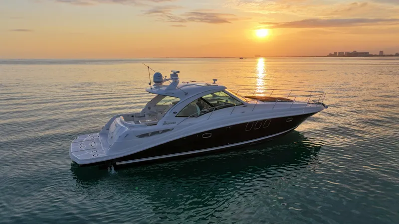 Slide: The Image of 2008 Sea Ray 48 Sundancer yacht at sunset on calm waters. - 2