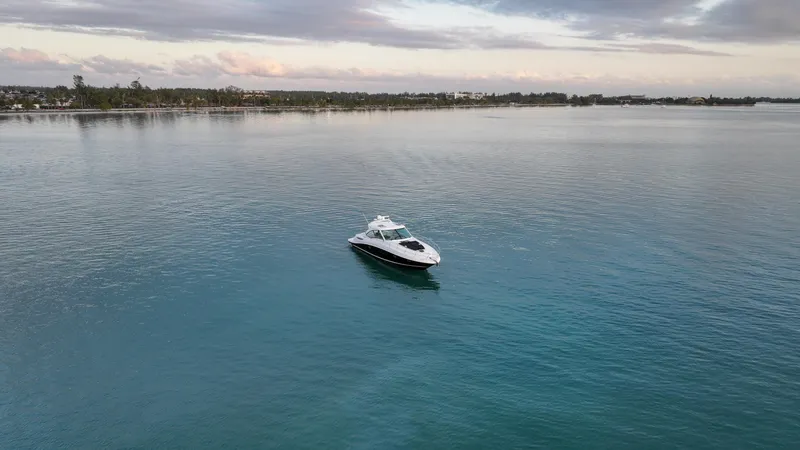 Slide: The Image of 2008 Sea Ray 48 Sundancer yacht on calm waters under a cloudy sky. - 20