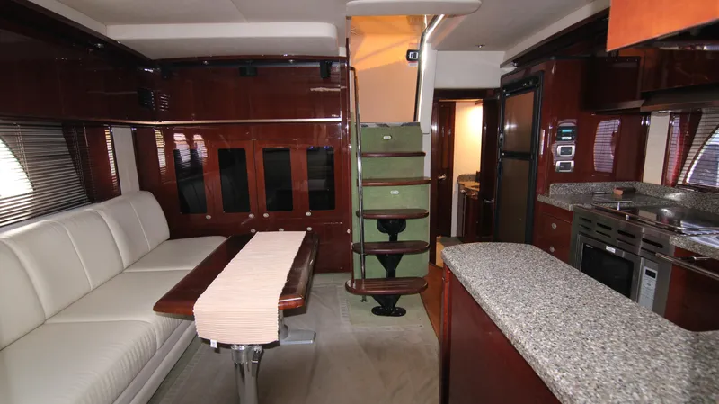 Slide: The Image of Luxurious interior of 2008 Sea Ray 48 Sundancer yacht with modern kitchen and seating area. - 28