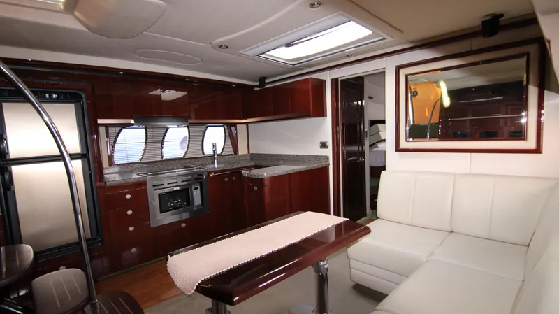 Slide: The Image of Luxurious interior of 2008 Sea Ray 48 Sundancer yacht with modern kitchen and seating area. - 29