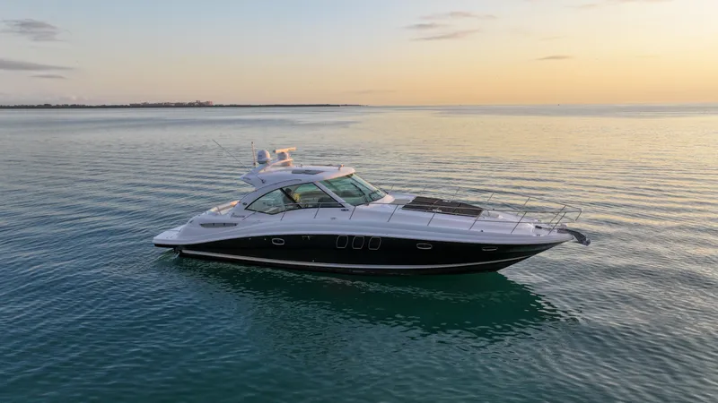 Slide: The Image of 2008 Sea Ray 48 Sundancer yacht on calm water at sunset. - 3