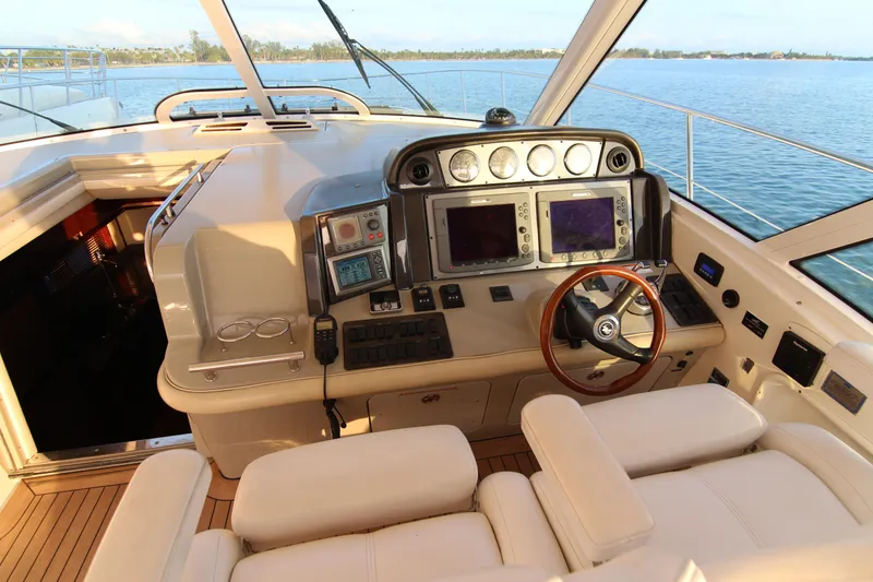 Slide: The Image of Helm of 2008 Sea Ray 48 Sundancer yacht with modern navigation equipment and leather seating. - 31