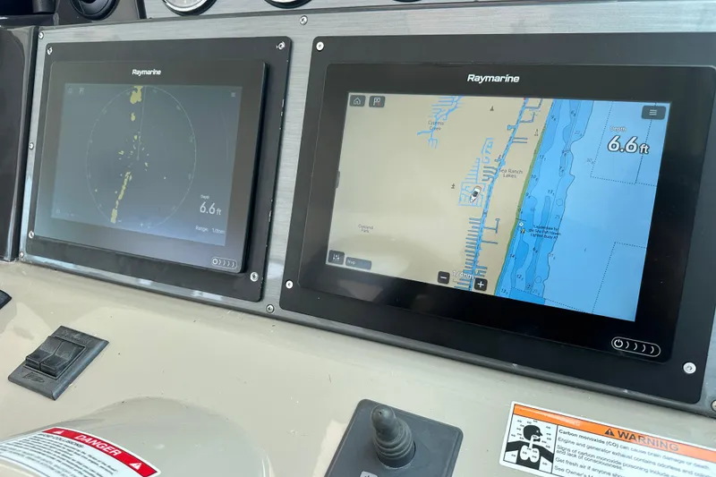 Slide: The Image of Control panel of a 2008 Sea Ray 48 Sundancer with Raymarine navigation displays. - 34