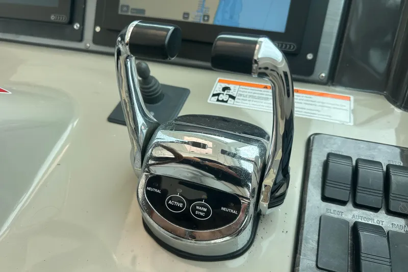 Slide: The Image of Control panel of a 2008 Sea Ray 48 Sundancer yacht with throttle levers. - 36