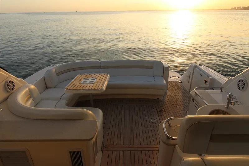 Slide: The Image of 2008 Sea Ray 48 Sundancer yacht deck at sunset, featuring elegant seating and ocean view. - 37