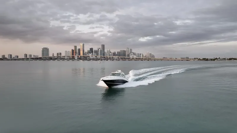 Slide: The Image of 2008 Sea Ray 48 Sundancer cruising near city skyline under cloudy skies. - 40