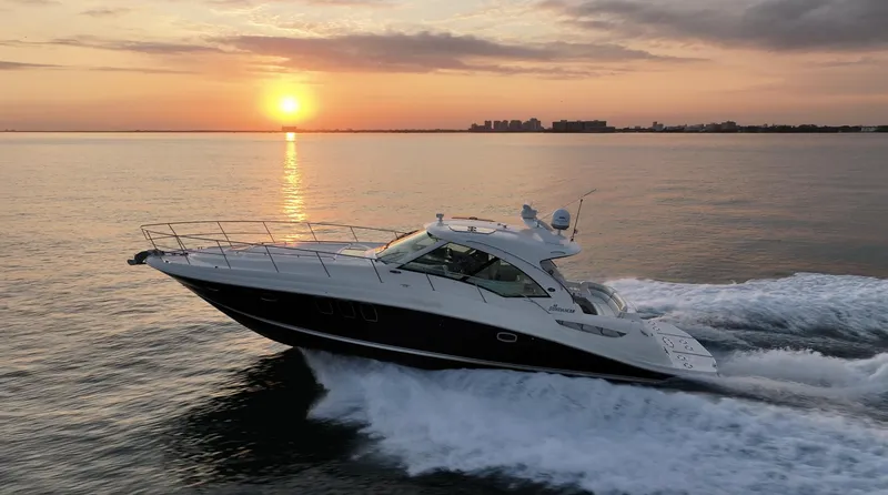 Slide: The Image of 2008 Sea Ray 48 Sundancer yacht cruising at sunset on calm waters. - 41