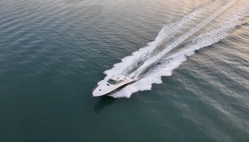 Slide: The Image of 2008 Sea Ray 48 Sundancer cruising on open water, leaving a wake behind. - 46