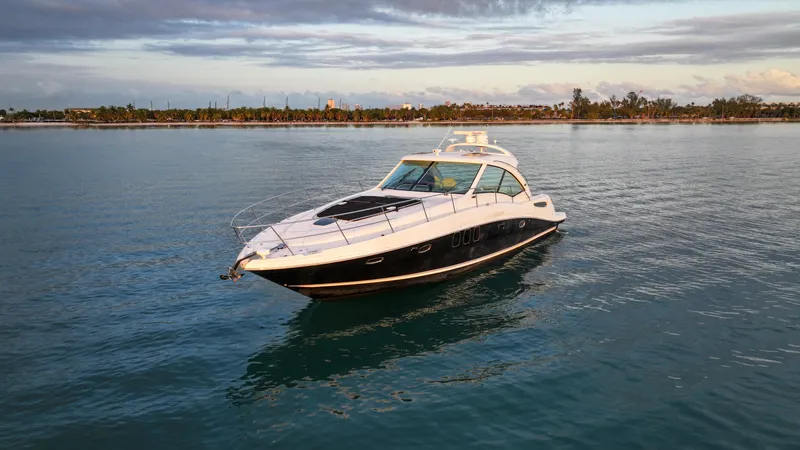 Slide: The Image of 2008 Sea Ray 48 Sundancer yacht cruising on calm waters at sunset. - 5