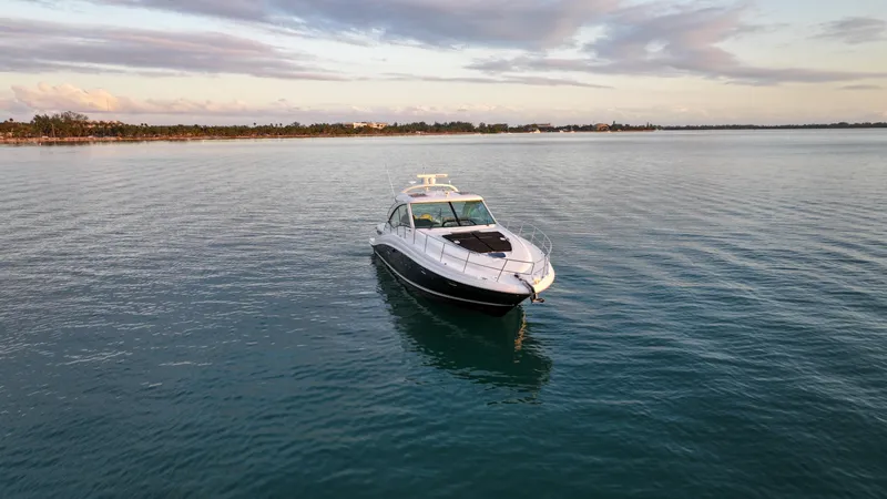 Slide: The Image of 2008 Sea Ray 48 Sundancer yacht on calm water at sunset. - 6