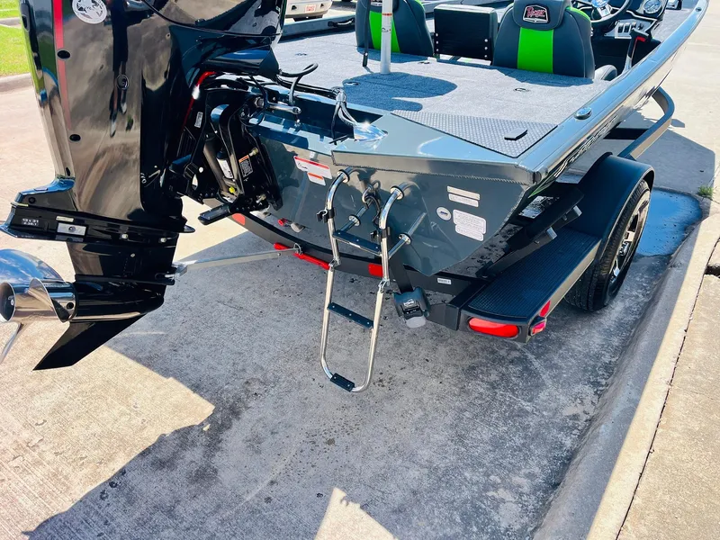 Slide: The Image of 2025 Ranger RT188C boat rear view with motor and ladder on trailer. - 13