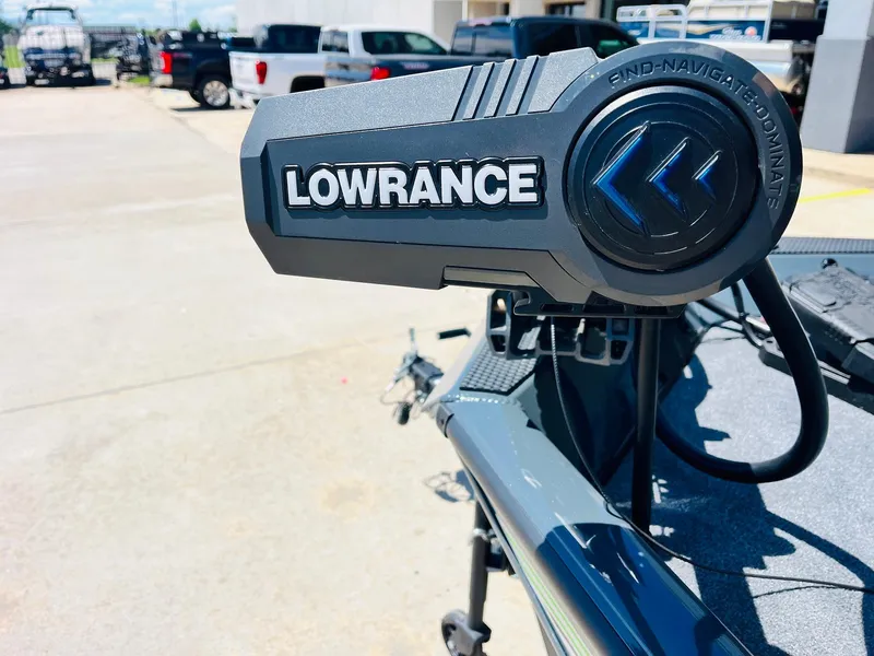 Slide: The Image of Lowrance equipment on 2025 Ranger RT188C boat, outdoor setting with vehicles in background. - 17
