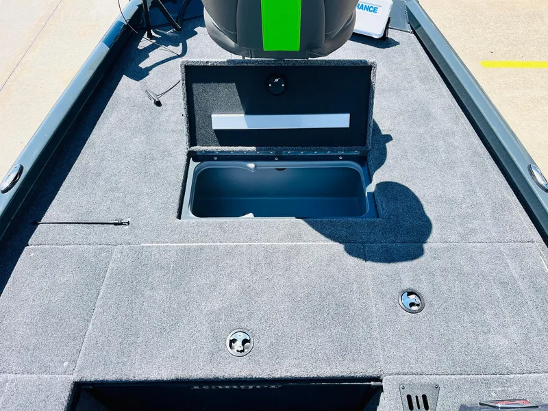Slide: The Image of 2025 Ranger RT188C boat interior with open storage compartment, gray carpet, and sleek design. - 21