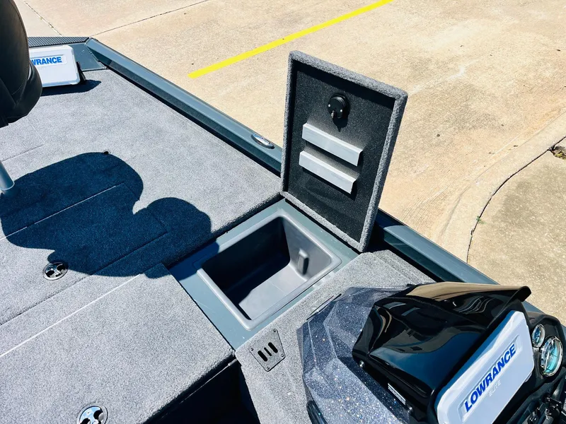 Slide: The Image of 2025 Ranger RT188C boat deck with open storage compartment and Lowrance electronics. - 25