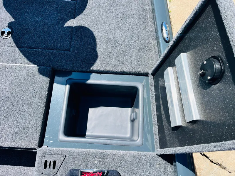 Slide: The Image of 2025 Ranger RT188C boat storage compartment with open lid, showcasing interior space. - 26
