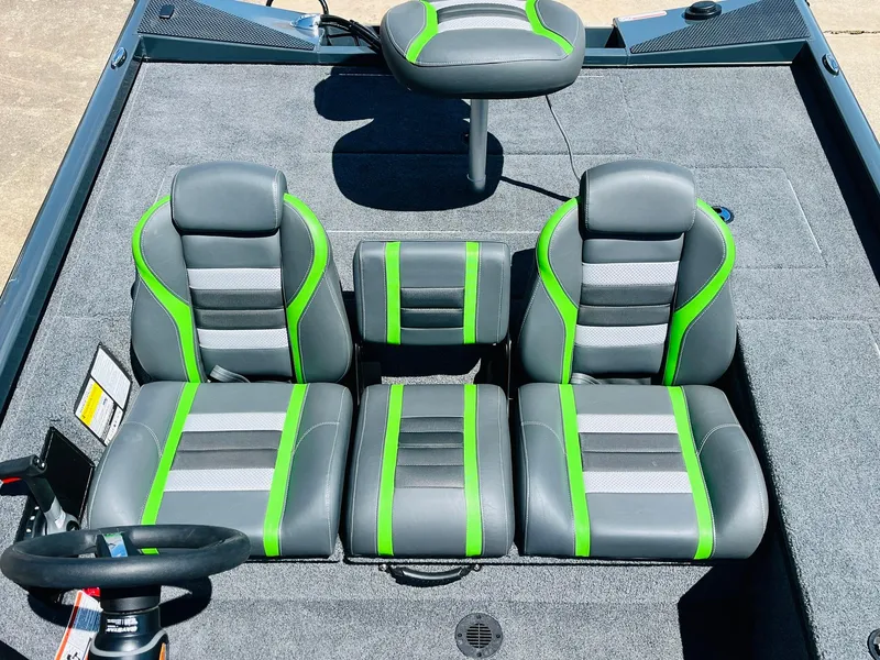 Slide: The Image of 2025 Ranger RT188C boat interior with gray and green seats, steering wheel visible. - 29