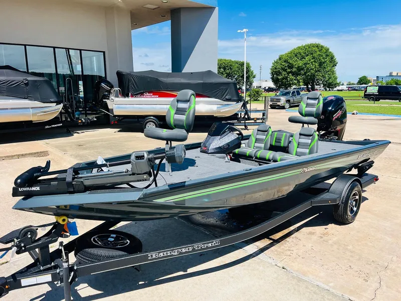 Slide: The Image of 2025 Ranger RT188C fishing boat with green accents on a trailer, parked outdoors. - 3