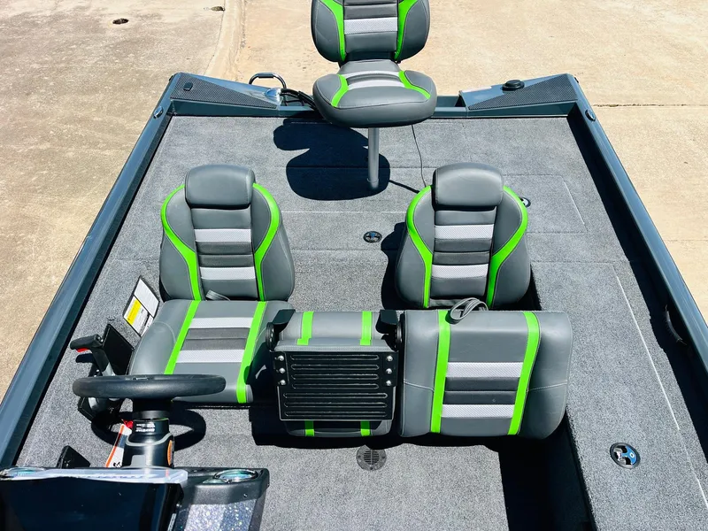 Slide: The Image of 2025 Ranger RT188C boat interior with gray and green seating, steering wheel, and console. - 37