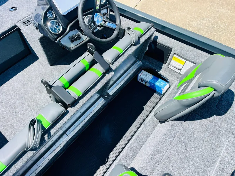 Slide: The Image of 2025 Ranger RT188C boat interior with gray and green seating, steering wheel, and storage compartment. - 39