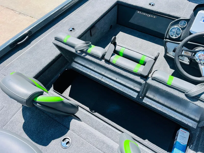 Slide: The Image of 2025 Ranger RT188C boat interior with gray and green seating, steering wheel, and storage compartments. - 40