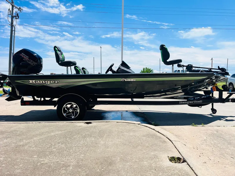 Slide: The Image of 2025 Ranger RT188C fishing boat on trailer, parked outdoors under blue sky. - 6