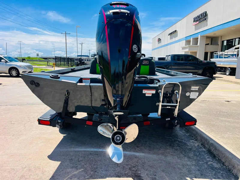 Slide: The Image of 2025 Ranger RT188C boat on trailer, rear view, parked outdoors near dealership. - 9