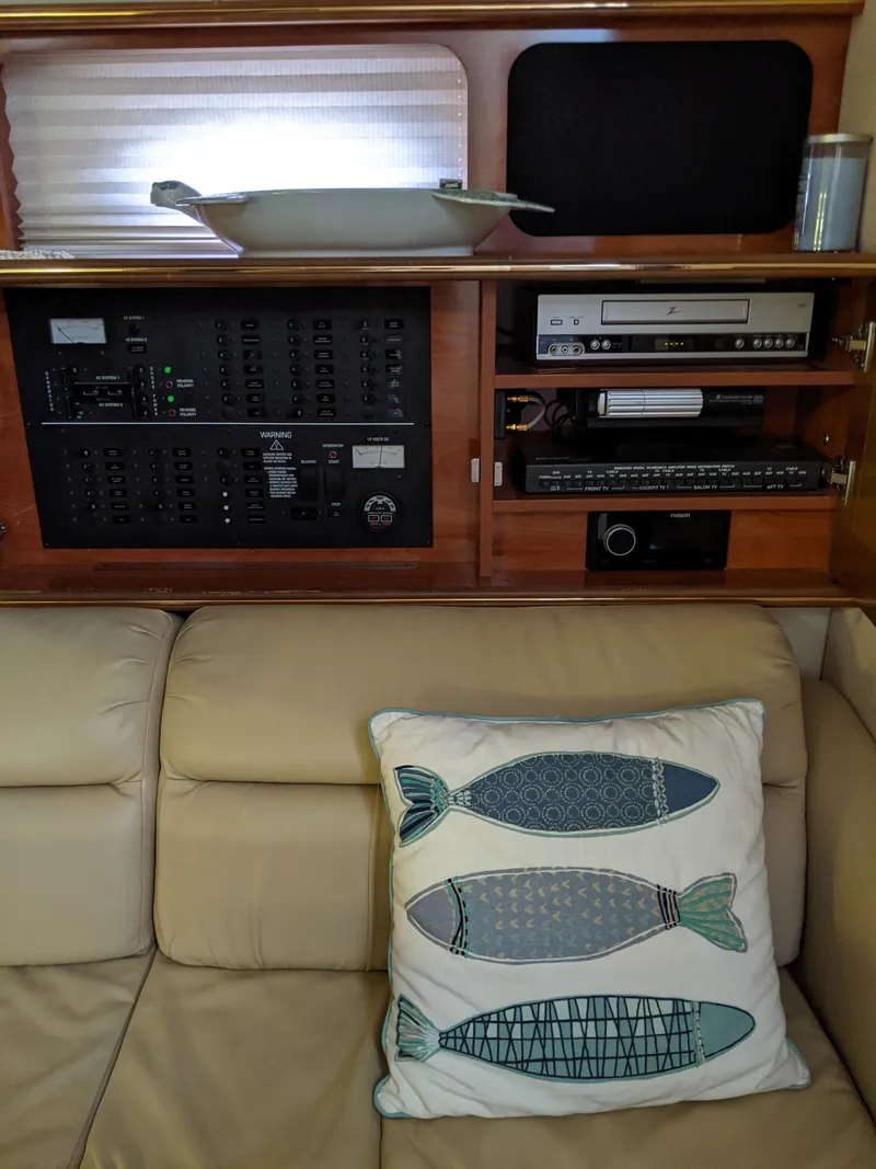 Slide: The Image of 2004 Rinker Fiesta Vee 410 interior with control panel and fish-themed pillow. - 15