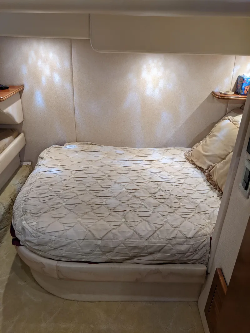 Slide: The Image of 2004 Rinker Fiesta Vee 410 cabin with cozy bed and soft lighting. - 21