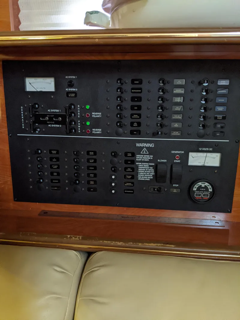 Slide: The Image of Control panel of a 2004 Rinker Fiesta Vee 410 boat, featuring various switches and gauges. - 28