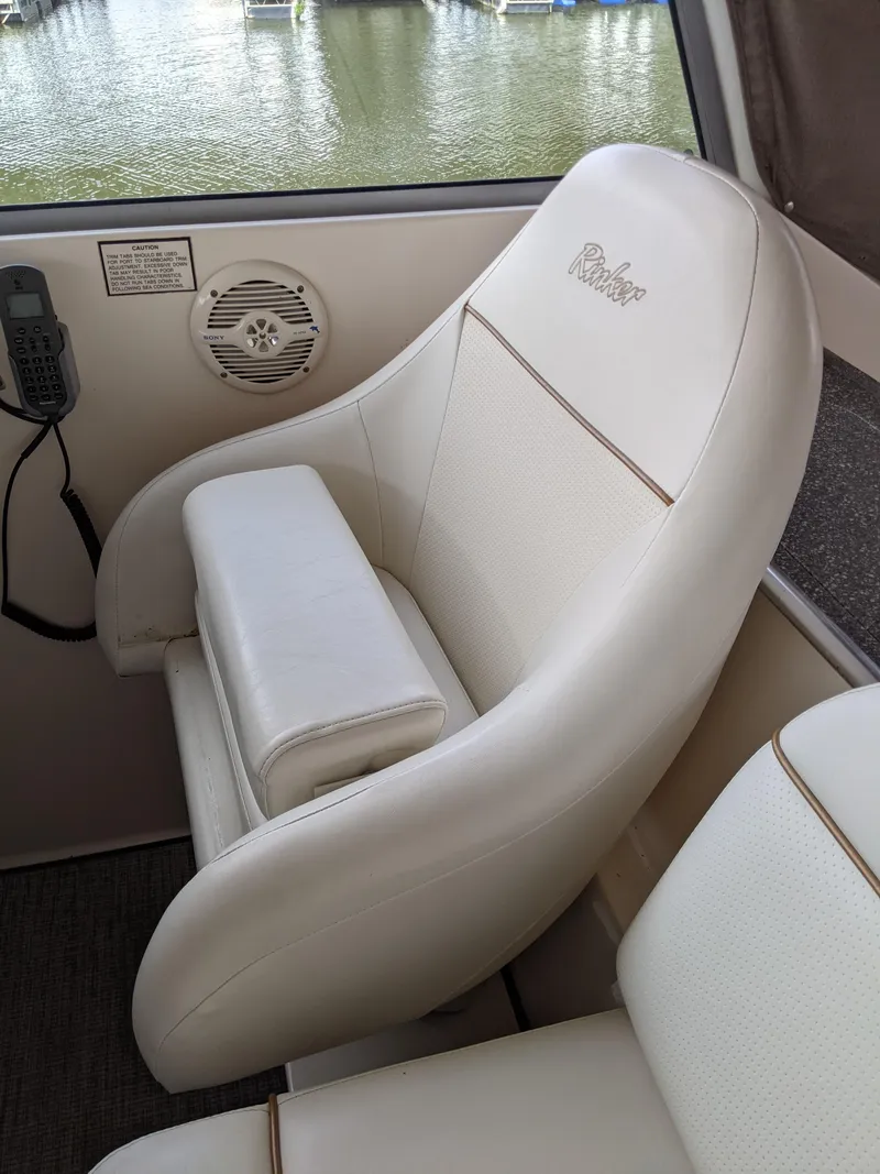 Slide: The Image of 2004 Rinker Fiesta Vee 410 boat interior with white cushioned seating. - 35