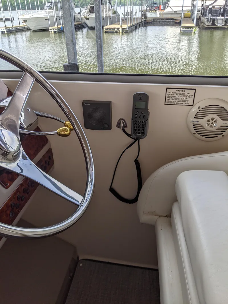 Slide: The Image of 2004 Rinker Fiesta Vee 410 helm with steering wheel and communication equipment. - 36