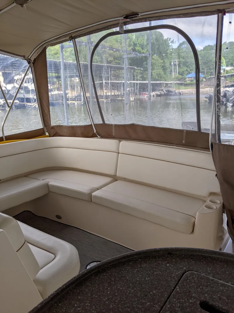 Slide: The Image of 2004 Rinker Fiesta Vee 410 boat interior with beige seating and lake view. - 45