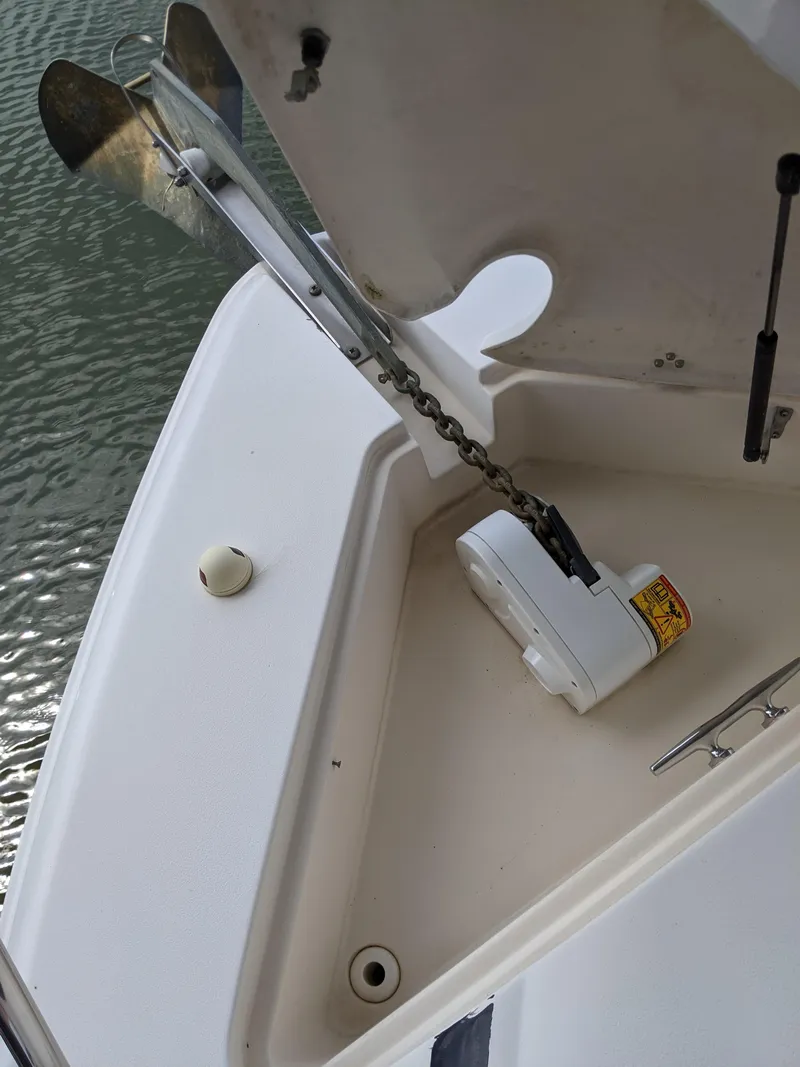 Slide: The Image of 2004 Rinker Fiesta Vee 410 anchor compartment with chain and winch. - 48