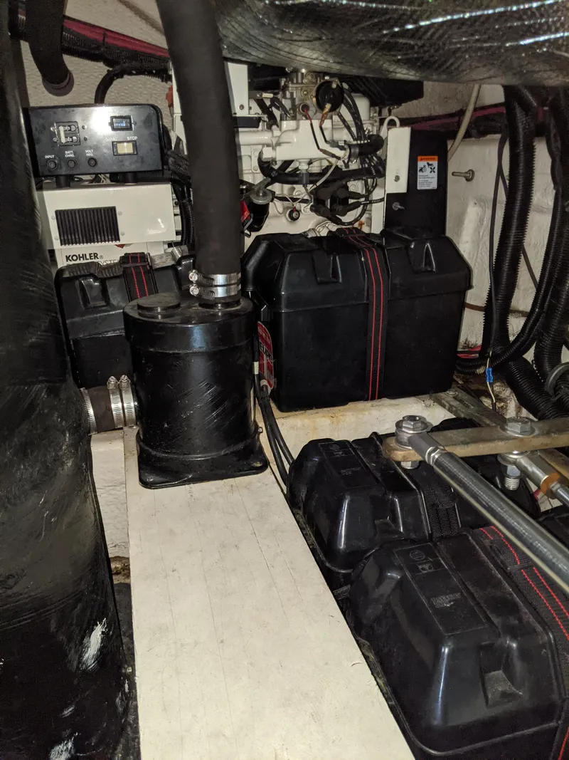 Slide: The Image of Engine room of 2004 Rinker Fiesta Vee 410 with Kohler generator and battery setup. - 49