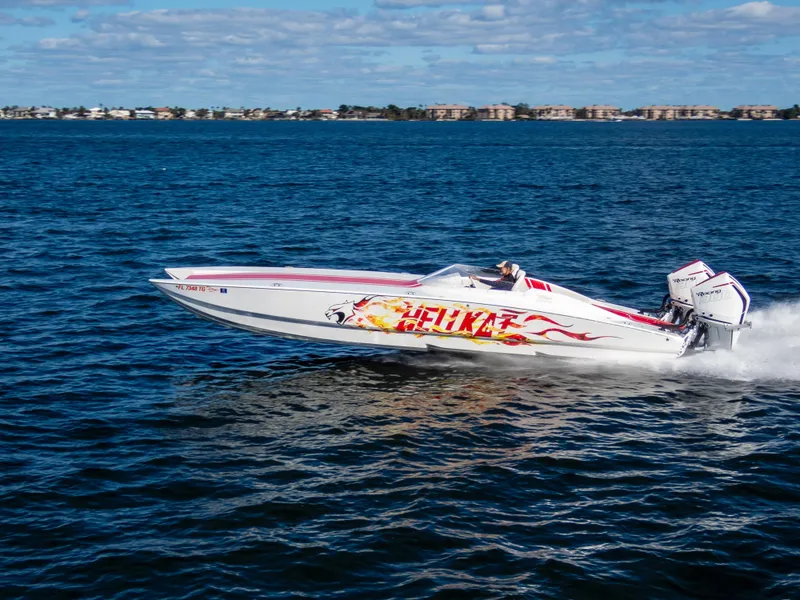 Slide: The Image of 2022 HellCat 32 Wide Body speedboat cruising on open water. - 0