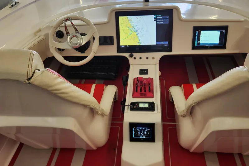 Slide: The Image of Cockpit of 2022 HellCat 32 Wide Body boat with modern navigation screens and controls. - 8