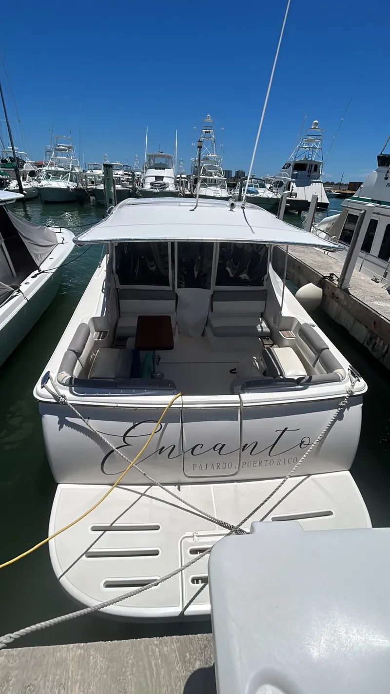 The Image of 2015 Tiara Yachts 3100 Coronet docked at marina under clear blue sky. - 1
