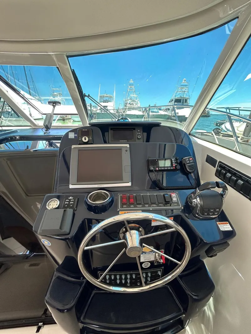 Slide: The Image of 2015 Tiara Yachts 3100 Coronet helm with navigation equipment and steering wheel. - 10