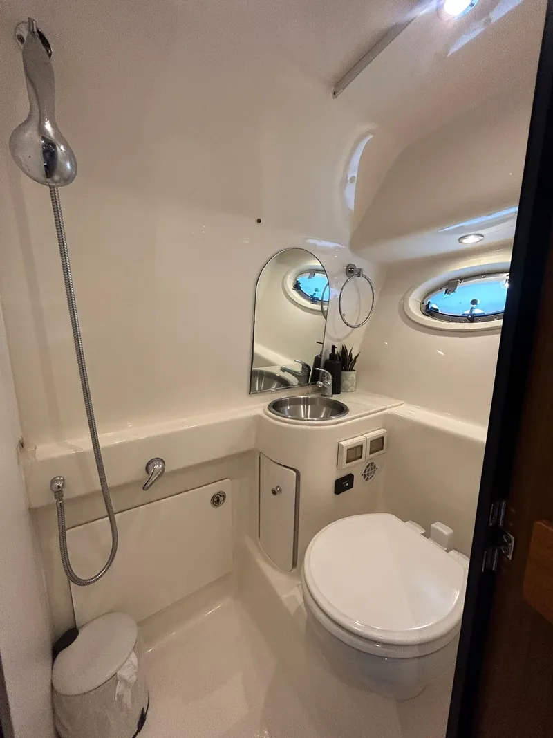 Slide: The Image of 2015 Tiara Yachts 3100 Coronet bathroom with sink, toilet, and showerhead. - 13