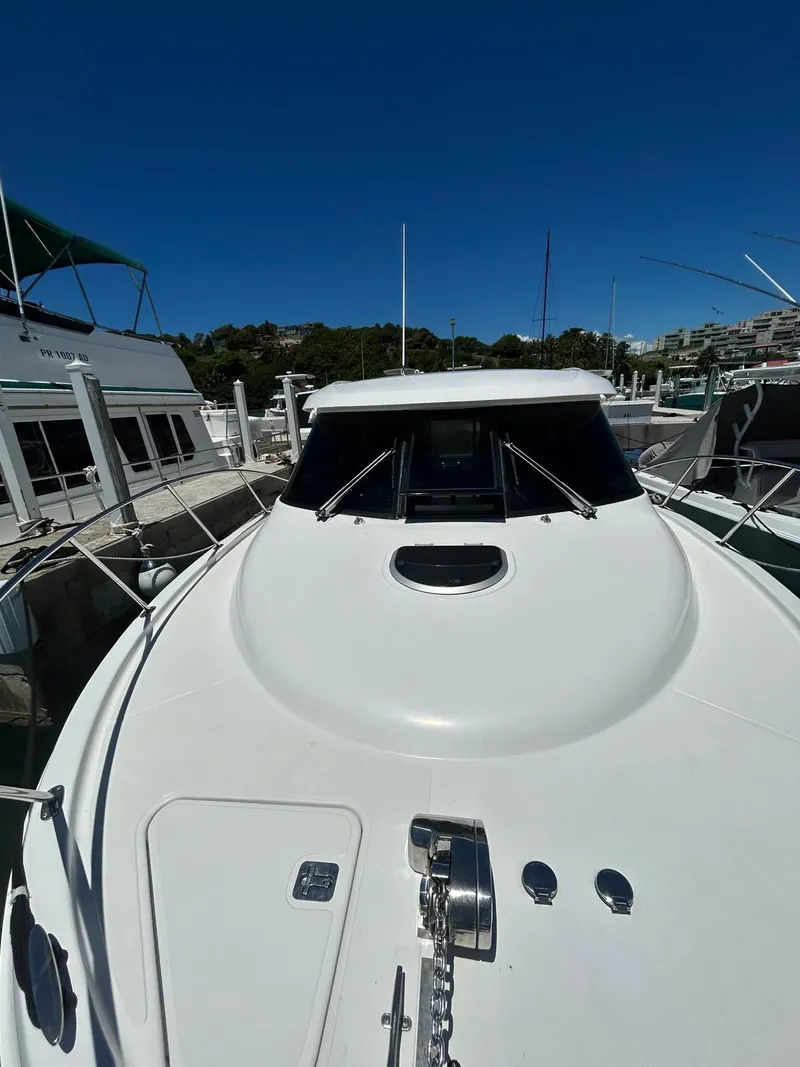 Slide: The Image of 2015 Tiara Yachts 3100 Coronet docked, showcasing sleek design and spacious deck. - 14