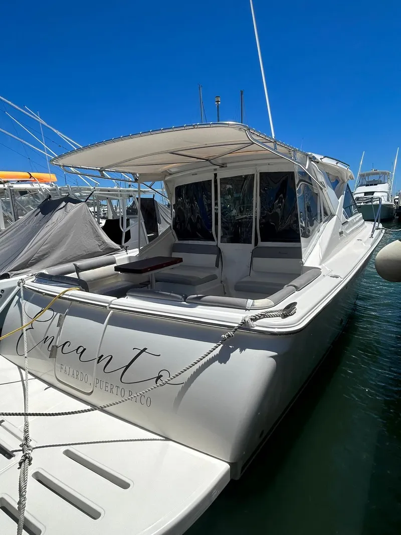 Slide: The Image of 2015 Tiara Yachts 3100 Coronet docked, featuring spacious seating and sleek design. - 3