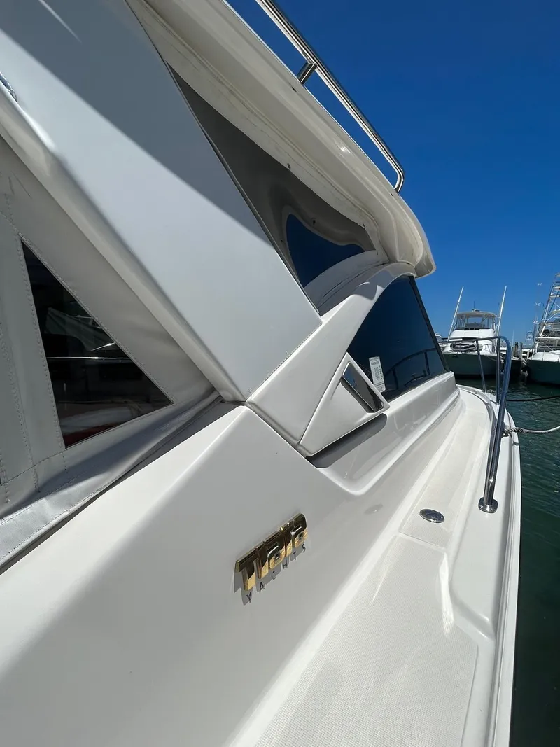 Slide: The Image of 2015 Tiara Yachts 3100 Coronet, sleek design, docked under clear blue sky. - 5