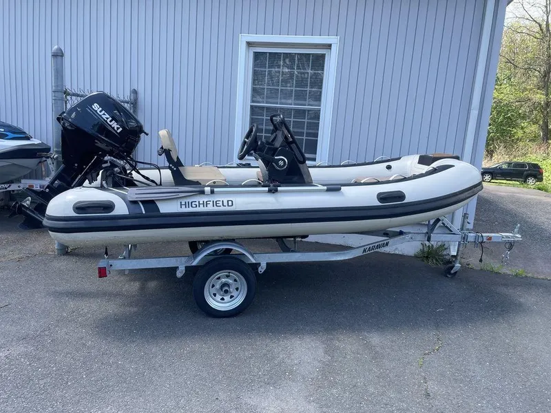 Slide: The Image of 2023 Highfield Classic 380 GT Limited boat on trailer, parked outside a building. - 12