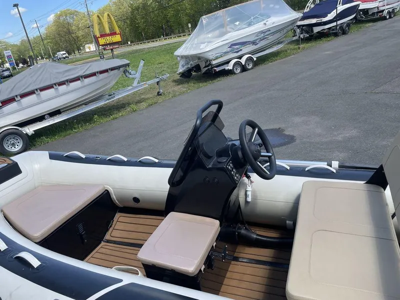 Slide: The Image of 2023 Highfield Classic 380 GT Limited boat interior with steering wheel and seating. - 13
