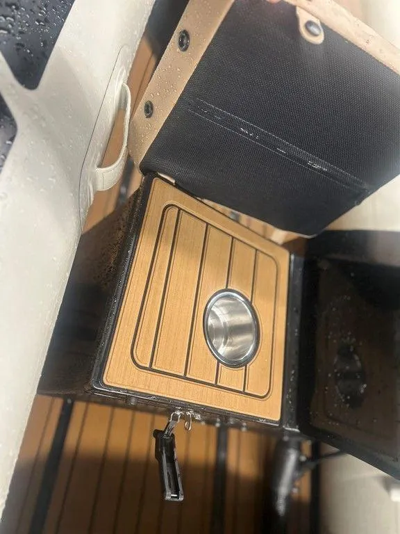 Slide: The Image of 2023 Highfield Classic 380 GT Limited boat interior with wooden panel and cup holder. - 7