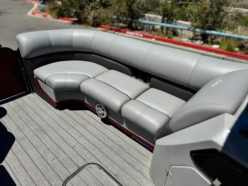 Slide: The Image of 2019 Manitou 23 Oasis boat with gray seating and deck flooring. - 11