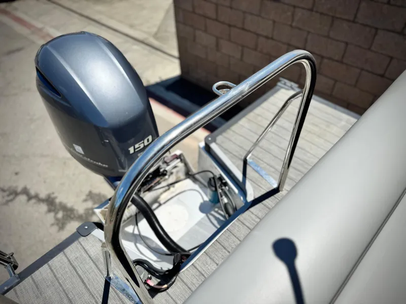 Slide: The Image of 2019 Manitou 23 Oasis boat with 150 horsepower outboard motor, docked on a sunny day. - 20