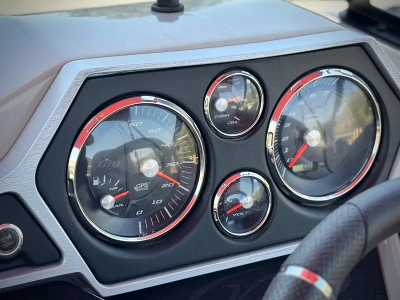 Slide: The Image of Dashboard of a 2019 Manitou 23 Oasis boat with speedometer and gauges. - 26