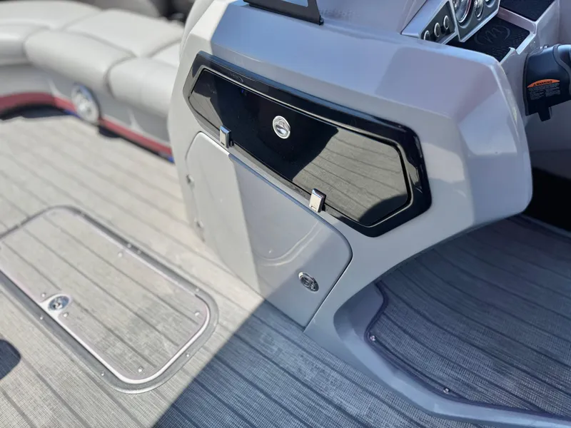 Slide: The Image of Interior of 2019 Manitou 23 Oasis boat with sleek dashboard and seating. - 27