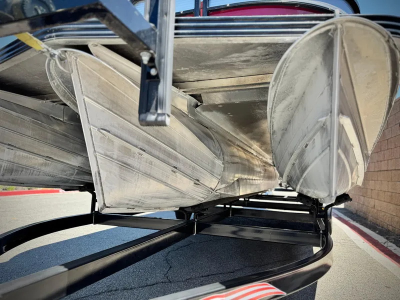 Slide: The Image of 2019 Manitou 23 Oasis pontoon boat underside view on trailer. - 3
